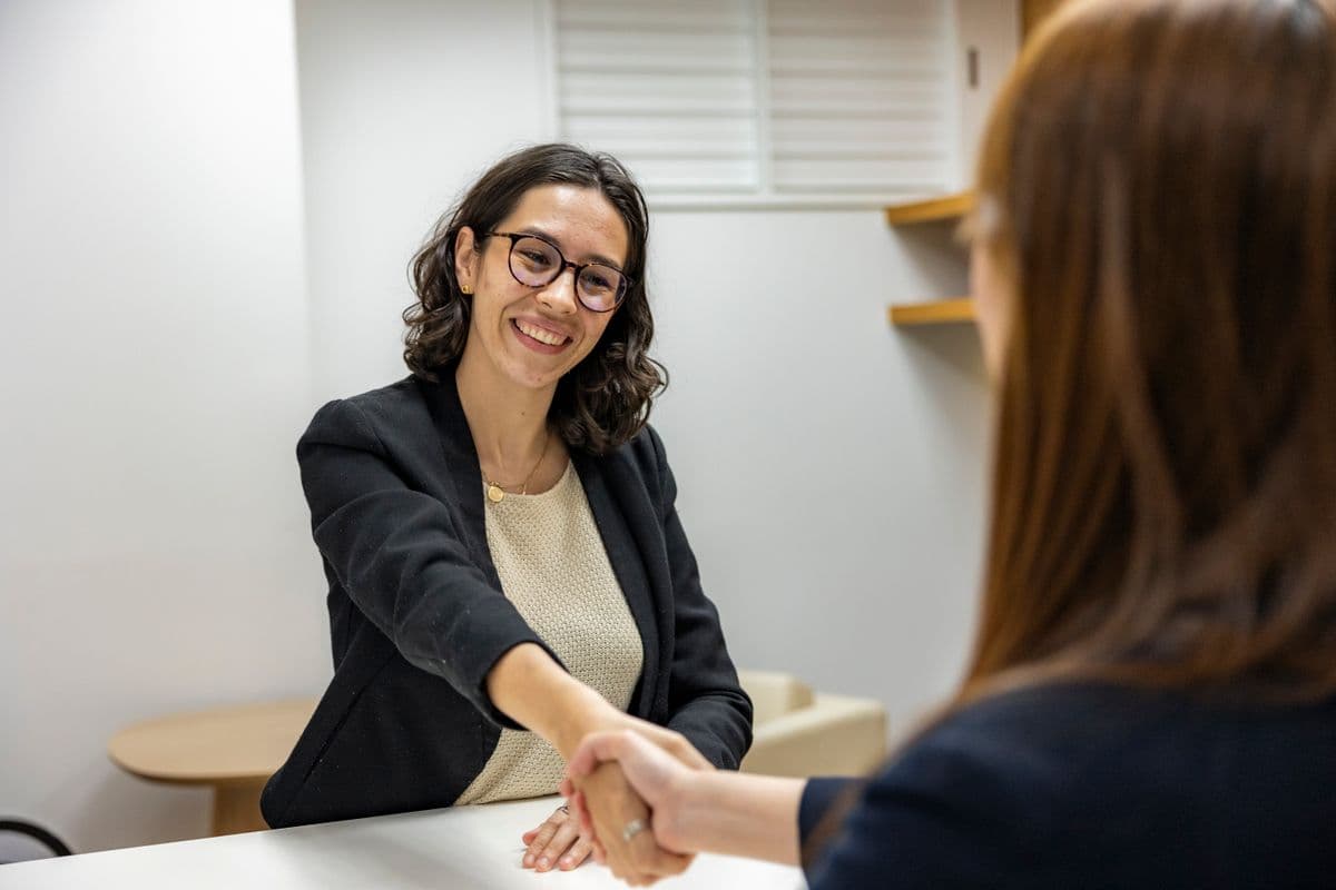Candidate completing an AI candidate screening video interview on a laptop from a professional home office setup