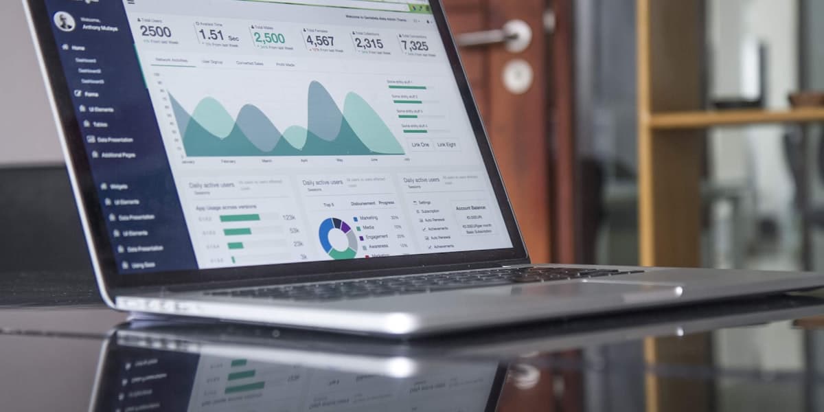 Talent acquisition leader reviewing AI hiring agents dashboard and recruiting pipeline metrics on laptop