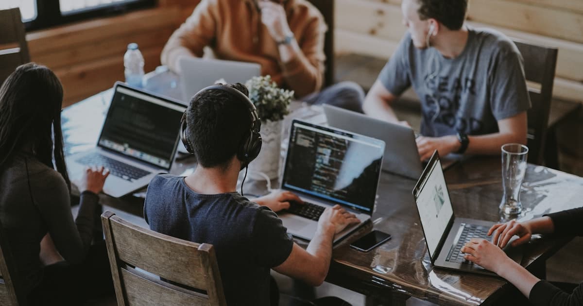 AI hiring agents in action: talent acquisition team collaborating at open-plan desks in a modern office