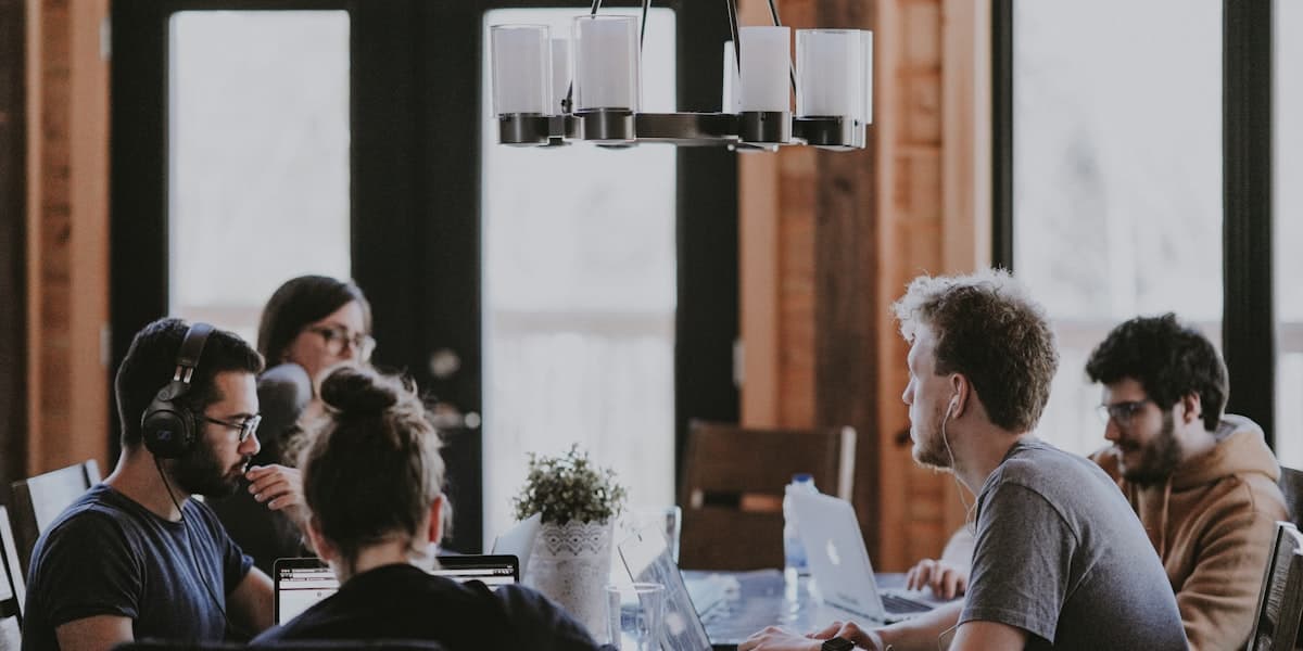 Recruiting team reviewing candidate data and hiring pipeline metrics around a conference table